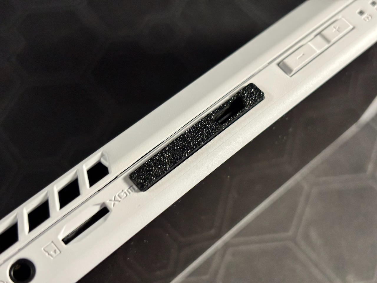 A close up photo of a black port cover but with a single USB-C port exposed
